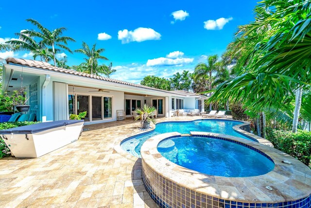 view of pool with ceiling fan, an in ground hot tub, and a patio area