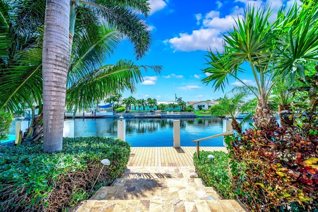 exterior space with a water view and a dock