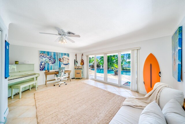 living room featuring ceiling fan and light tile patterned floors