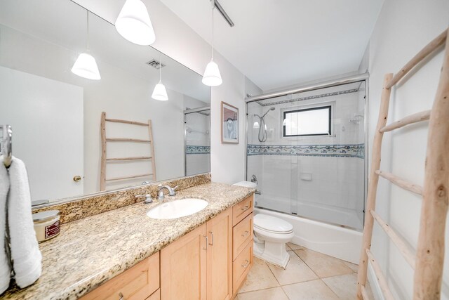 full bathroom featuring enclosed tub / shower combo, toilet, vanity, and tile patterned flooring