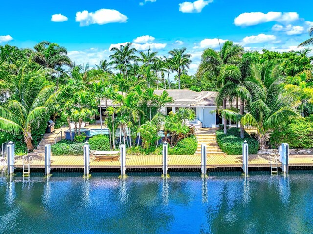 back of property featuring a water view