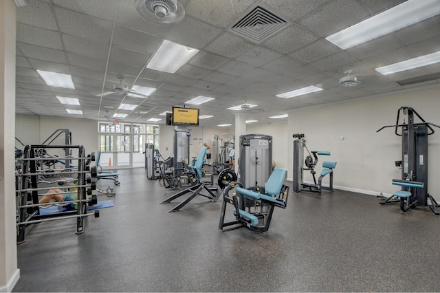 gym with a paneled ceiling