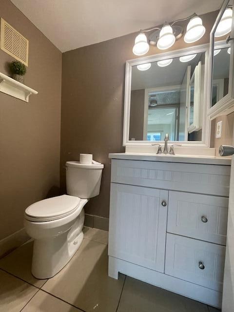 bathroom with tile patterned floors, vanity, and toilet