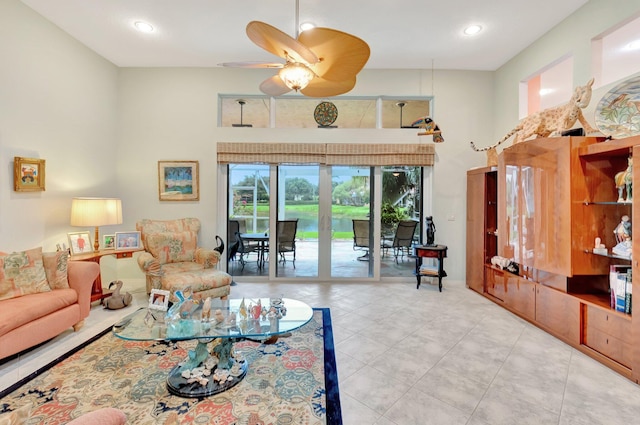 living area featuring a ceiling fan, recessed lighting, a high ceiling, and light tile patterned floors