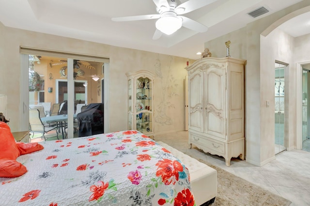 bedroom with visible vents, arched walkways, a ceiling fan, access to exterior, and light tile patterned flooring