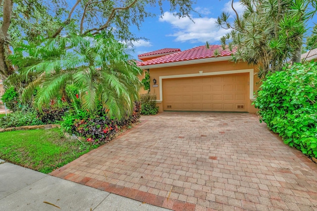 garage featuring decorative driveway