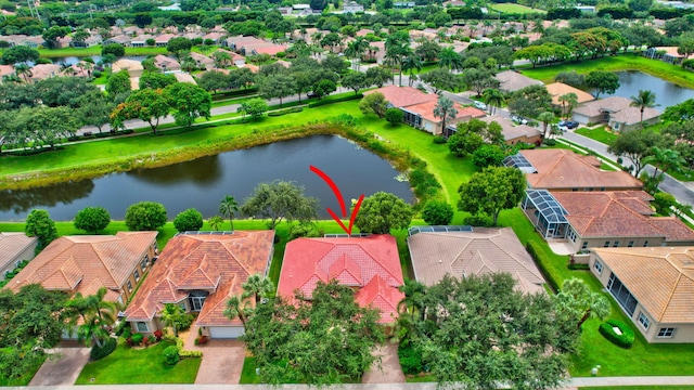 birds eye view of property with a water view and a residential view