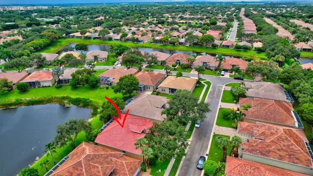 drone / aerial view with a water view and a residential view