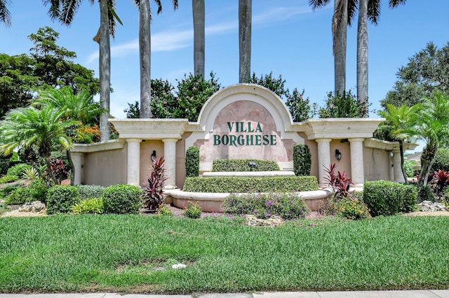 community sign featuring a lawn