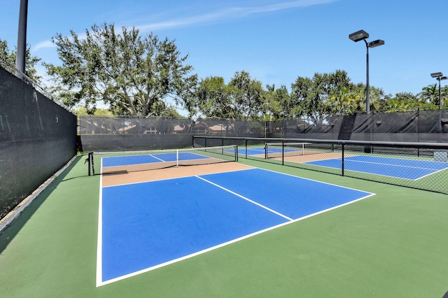 view of sport court featuring community basketball court and fence