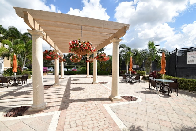 view of patio / terrace featuring outdoor dining space, fence, and a pergola