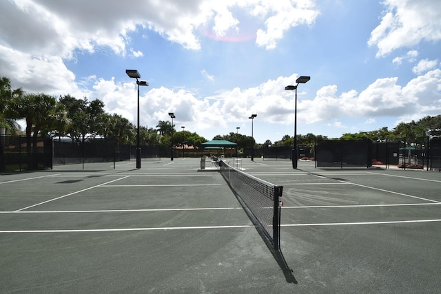 view of tennis court featuring fence