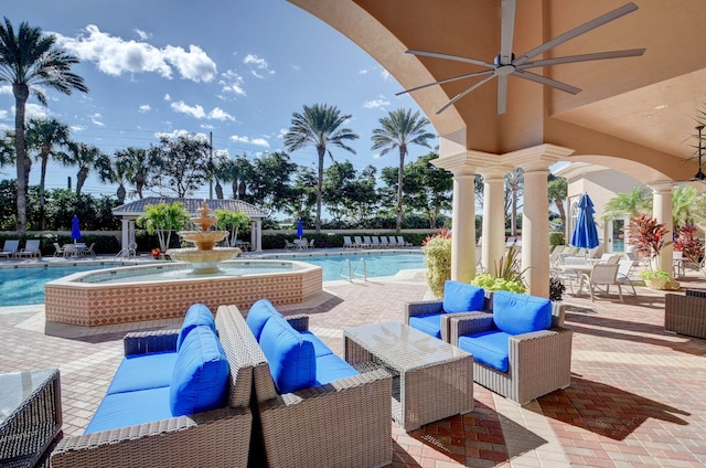 view of patio / terrace featuring a ceiling fan, a community pool, and an outdoor hangout area