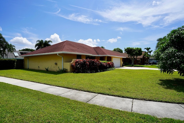 view of home's exterior with a yard and a garage