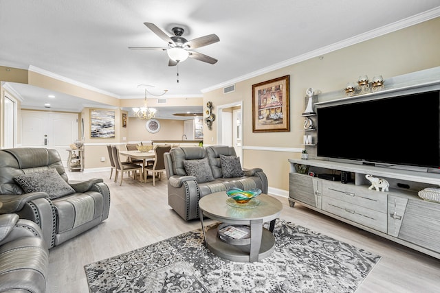 living room with ceiling fan with notable chandelier, wood finished floors, visible vents, baseboards, and ornamental molding