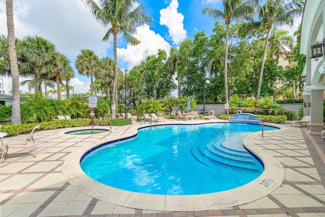 community pool featuring a community hot tub and a patio