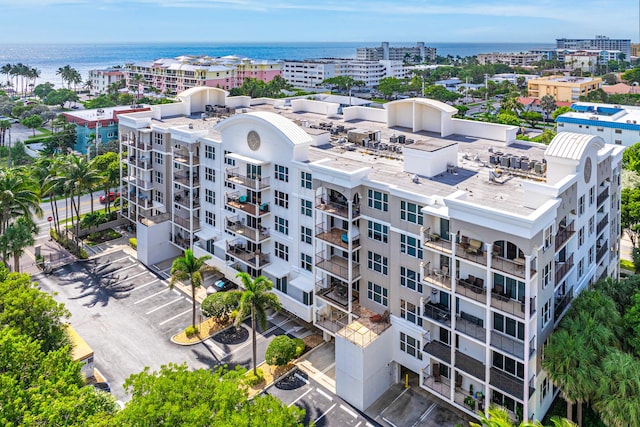 birds eye view of property with a view of city and a water view