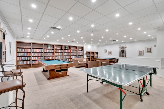 playroom featuring built in features, light carpet, and a drop ceiling