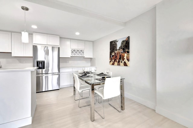 dining space featuring light wood-type flooring