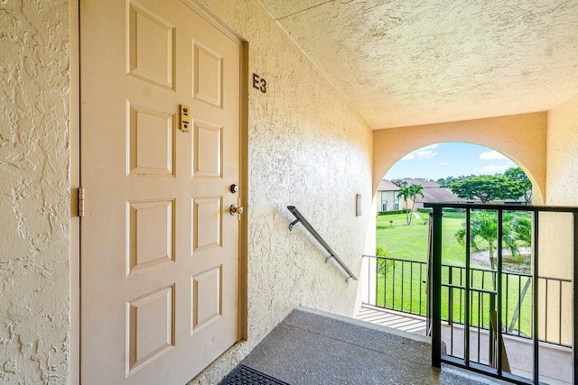 property entrance with stucco siding