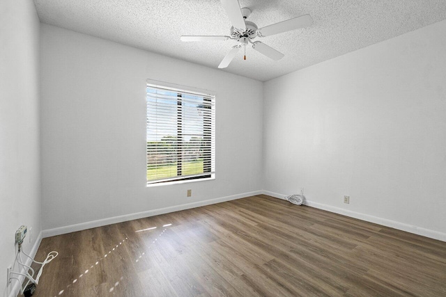 spare room featuring ceiling fan, wood-type flooring, and a textured ceiling