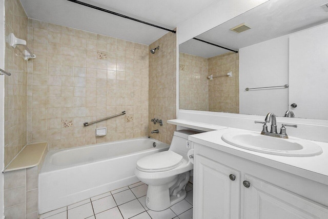 full bathroom featuring tile patterned floors, tiled shower / bath combo, vanity, and toilet