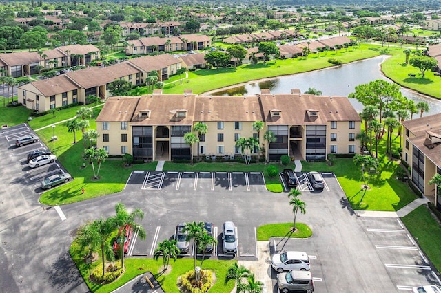 drone / aerial view featuring a residential view and a water view