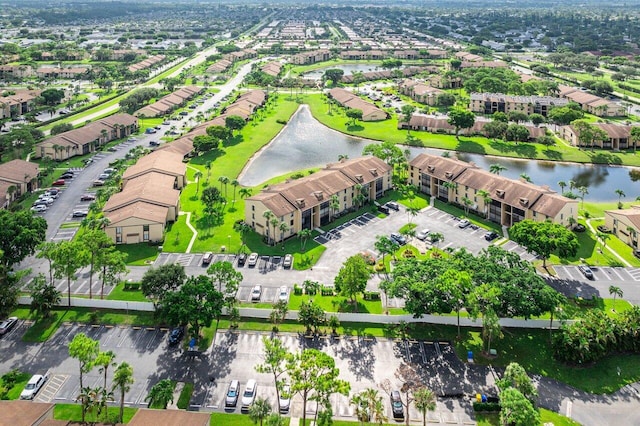 birds eye view of property featuring a water view and a residential view