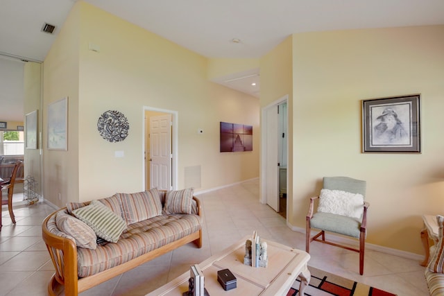 living room featuring light tile patterned flooring and high vaulted ceiling