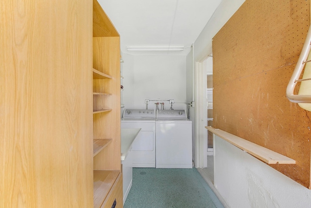 clothes washing area featuring carpet flooring and washer and dryer