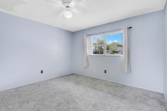 carpeted spare room with ceiling fan and a textured ceiling