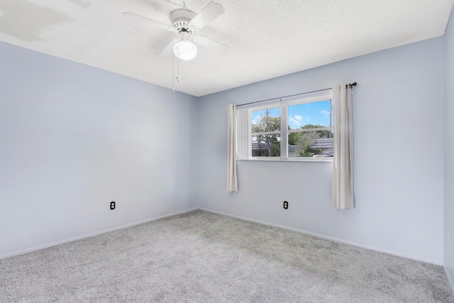 empty room with a textured ceiling, carpet floors, and ceiling fan