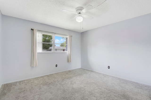 carpeted spare room with ceiling fan and a textured ceiling