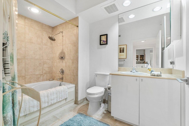 full bathroom with tile patterned floors, vanity, toilet, and tiled shower / bath combo