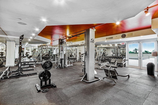 gym with a textured ceiling and french doors