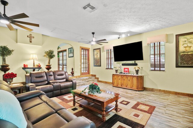 tiled dining area with a fireplace, brick wall, ceiling fan, and french doors