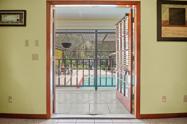 doorway to outside with light tile patterned flooring