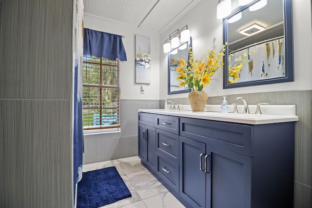 bathroom with tile walls, tile patterned flooring, vanity, and ornamental molding