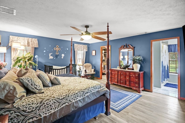 bedroom featuring multiple windows, wood finished floors, and visible vents