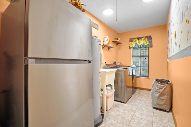 clothes washing area featuring light tile patterned flooring and separate washer and dryer