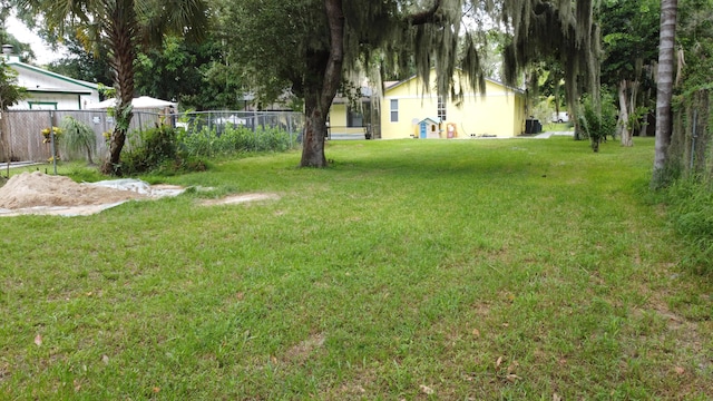 view of yard with fence and cooling unit