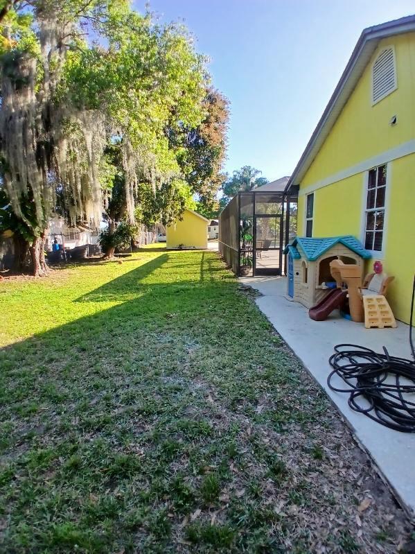 view of yard featuring a patio and a lanai