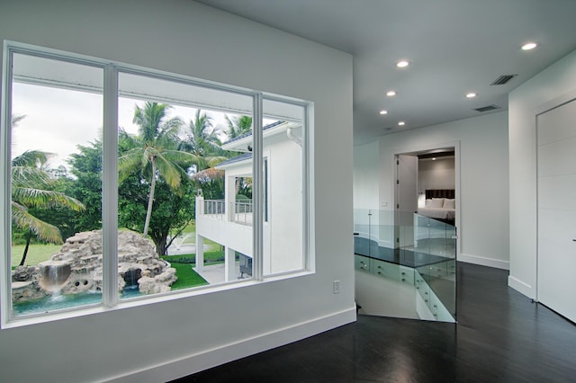 unfurnished room with dark hardwood / wood-style floors