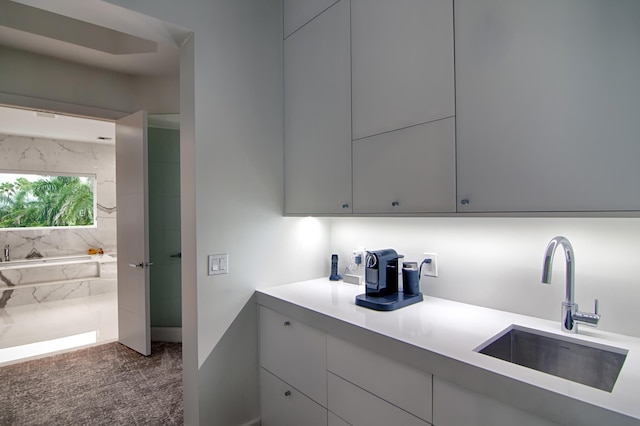 interior space with gray cabinets and sink