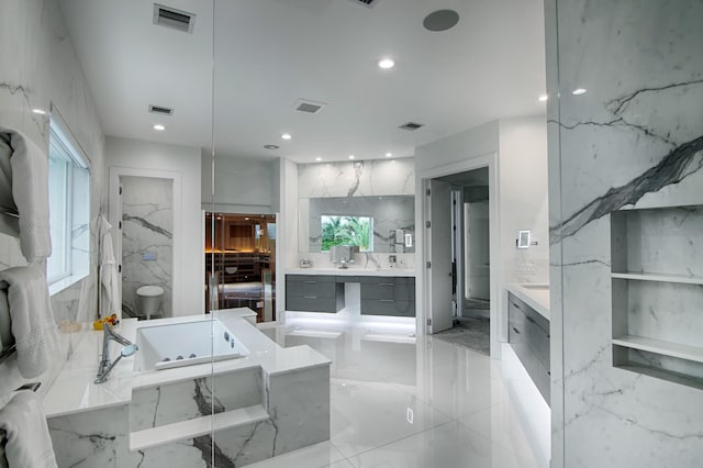 bathroom featuring vanity and a bath