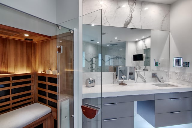 bathroom featuring vanity and a shower with shower door