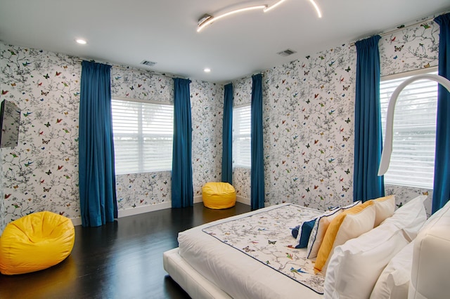 bedroom with dark hardwood / wood-style floors