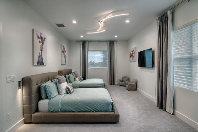 bedroom featuring light carpet