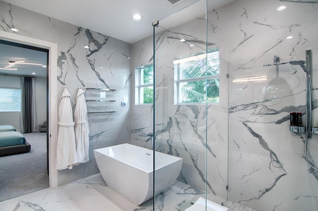 bathroom featuring plus walk in shower and a wealth of natural light