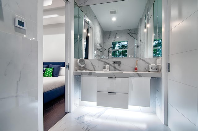 bathroom with decorative backsplash and vanity